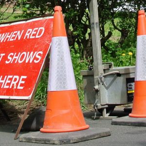 Traffic management equipment for hire – sign and cones on road